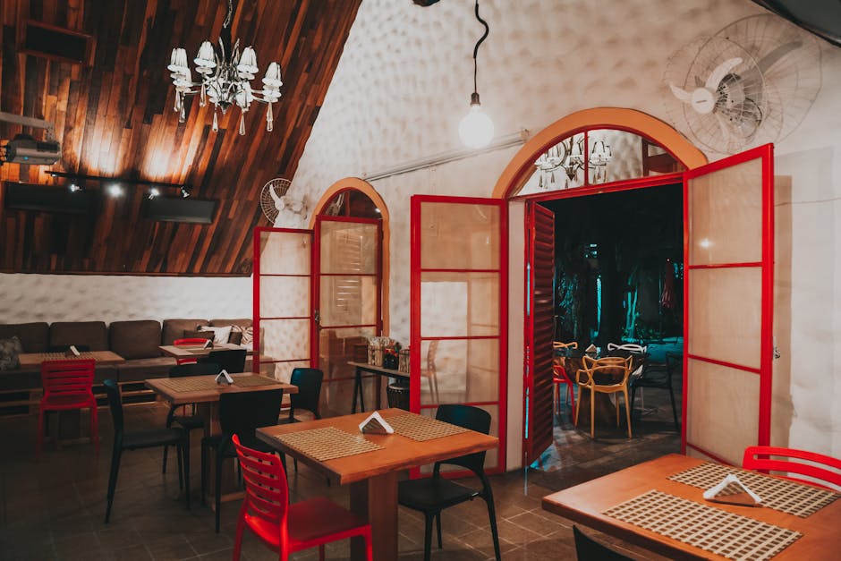 Warm and inviting restaurant interior featuring wooden details and red accents for a cozy atmosphere