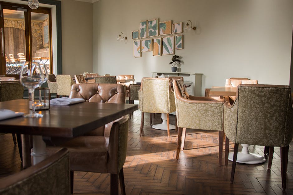 Stylish dining area with elegant chairs, soft lighting, and artistic wall decor