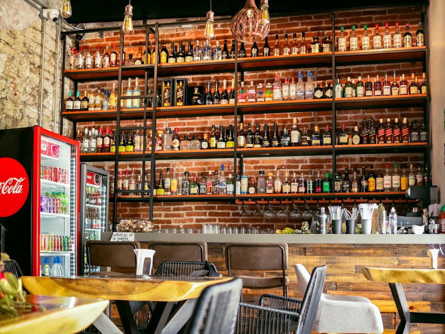 Cozy restaurant bar with industrial design and diverse beverage selection, ideal for dining ambiance