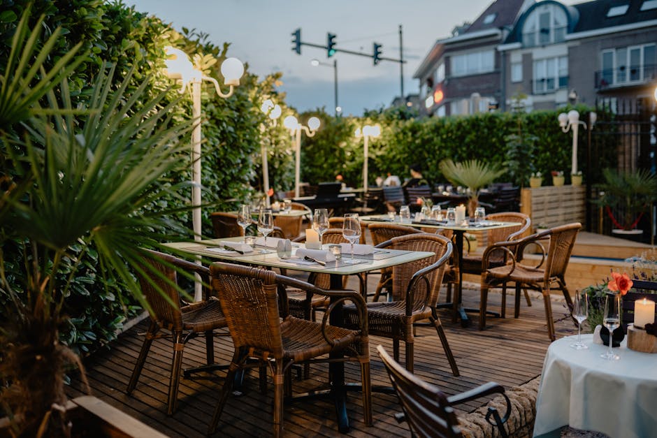 Cozy outdoor restaurant terrace with ambient lighting and elegant table setup